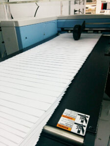 image of The New Digital Multi-Media Print System Busy Printing Envelopes at Westmount Signs & Printing